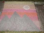 sidewalk chalk art tall blue mountain peaks with layers of pink yellow and orange sunset and full moon 
