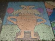sidewalk chalk representation of Dr Seuss character standing with hands on hips blue background purple and red lollypops