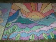 sidewalk chalk art line drawings of purple pink and blue mountains and line drawn sunset of red yellow pink and oranges