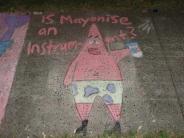 sidewalk chalk art drawing of pink underwater character with yellow shorts with blue dots holding a mayonnaise jar