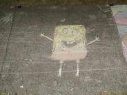 sidewalk chalk art drawing of square yellow underwater character with a red tie