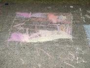 child's sidewalk chalk art pink yellow and blue scribbles