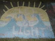 sidewalk chalk art with yellow sunshine blue skies white clouds and text LIGHT